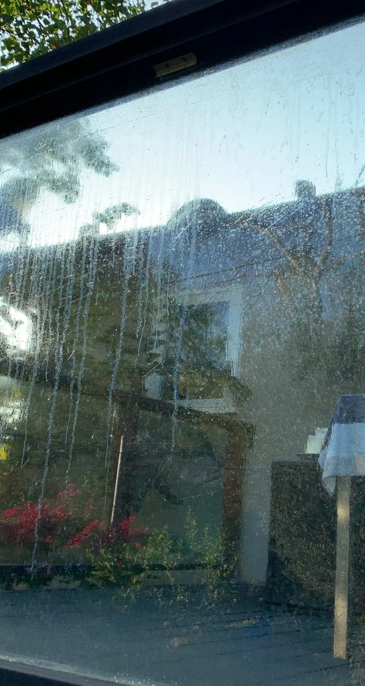 Window glass streaked and clouded with water spots, before cleaning